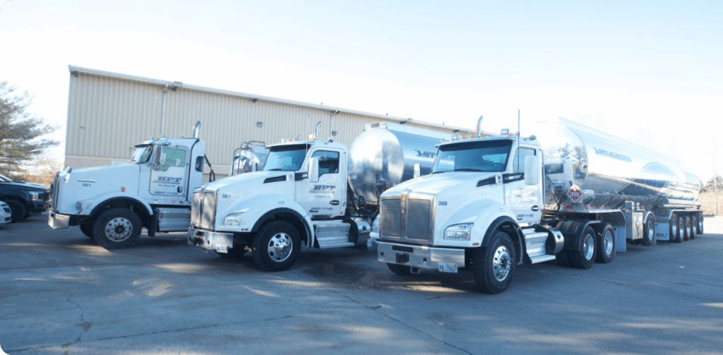 lined up petroleum transport trucks in front of building